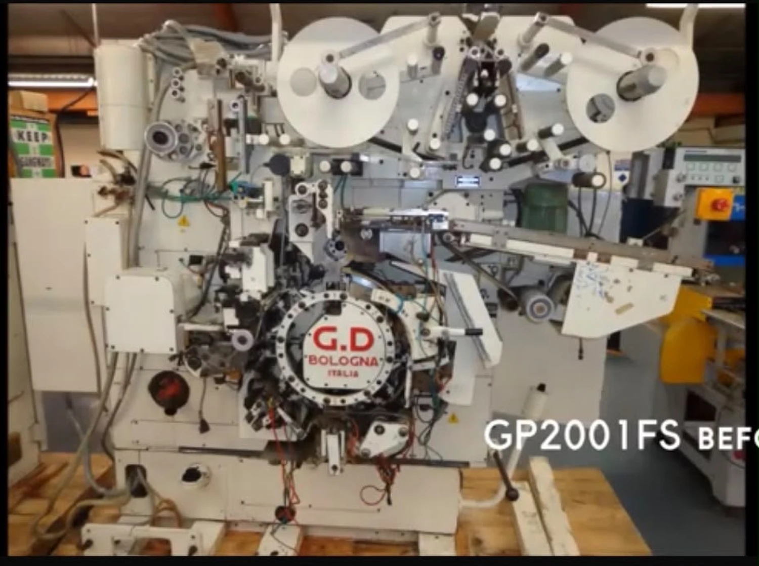 IGEMA Technology GmbH&Co.KG - Maschinenbau & Verpackungstechnik Service - GP2002 Nachher: ​​Generalüberholte, hochpräzise weiße Hochgeschwindigkeits-Verpackungsmaschine mit präzisen mechanischen Komponenten und Folienrollen.